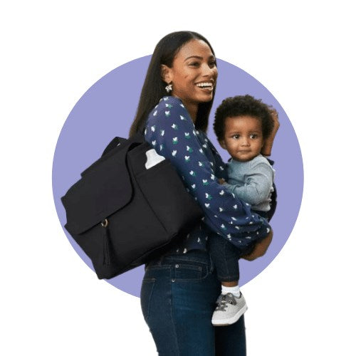 a picture of a lady holding her baby and diaper bag.  Shop our collection of diaper bags.